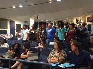 People-standing-at-city-council-in-support-of-paid-sick-leave-1